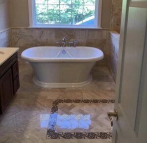 An elegant bathroom featuring a freestanding tub and decorative tile floor installed by Pro Remodel LLC in St. Charles, MO.