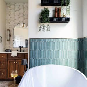 An elegant bathroom remodel featuring a freestanding tub and wooden vanity by Rockin' Remodeling LLC in Austin, TX