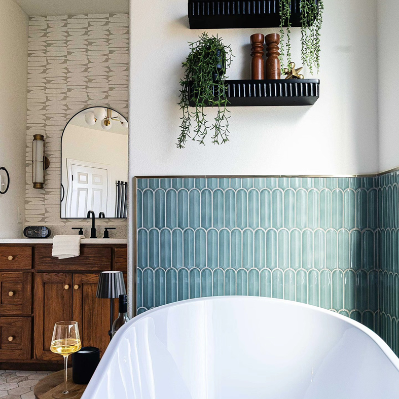An elegant bathroom remodel featuring a freestanding tub and wooden vanity by Rockin' Remodeling LLC in Austin, TX
