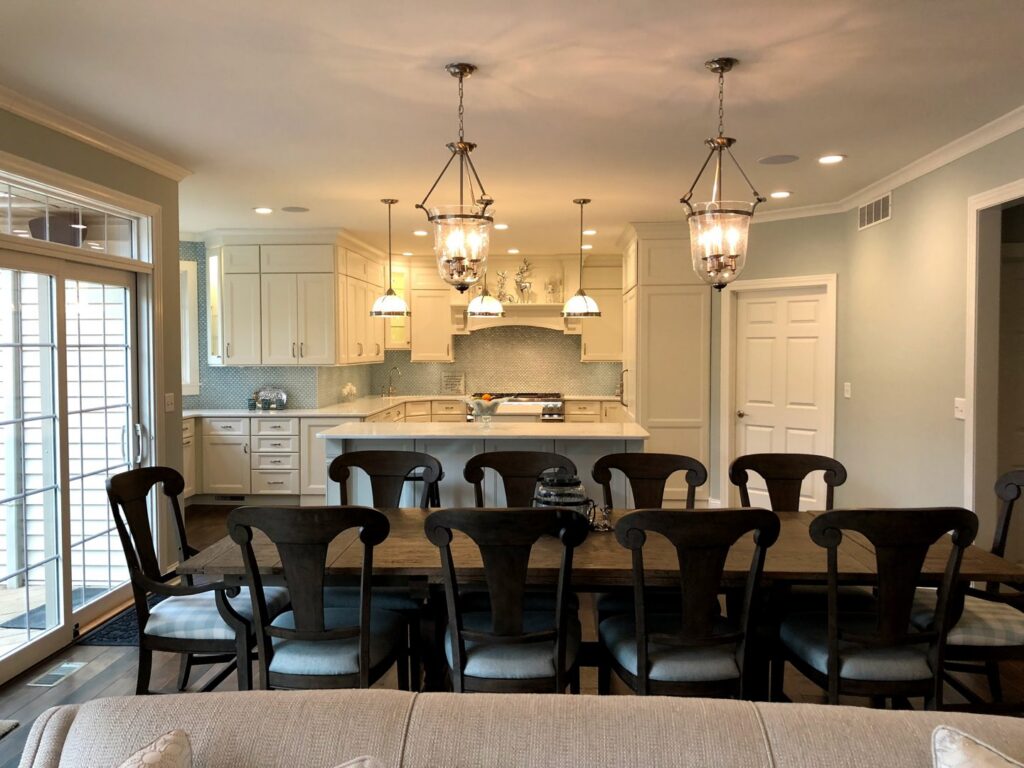 An elegant dining room with a view into a light-filled kitchen, completed by Creasey Construction of Illinois, Inc. in Springfield, IL