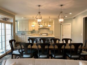 An elegant dining room with a view into a light-filled kitchen, completed by Creasey Construction of Illinois, Inc. in Springfield, IL