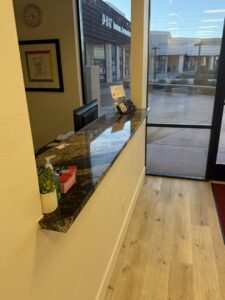 An elegant bar area featuring a striking green marble backsplash installed by Oddonetto Granite & Marble LLC in Phoenix, AZ.