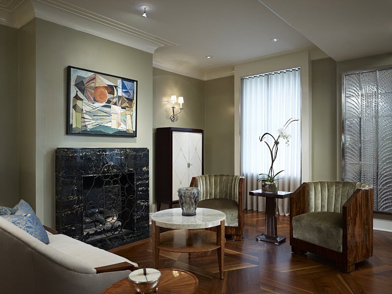 An elegant living room renovation featuring a black marble fireplace by S.N. Peck Builder, Inc. in Chicago, IL.