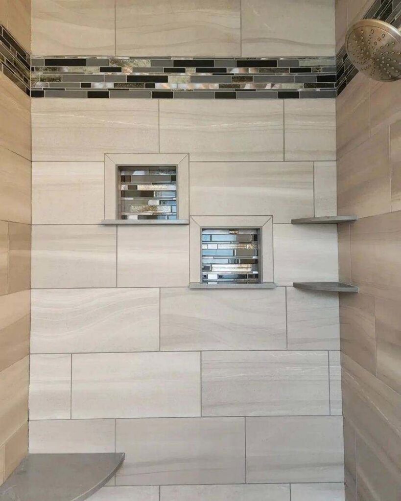 An elegant tiled shower featuring two recessed niches with a decorative accent strip, completed by Ace Tile & Finishing LLC in Philadelphia, PA.