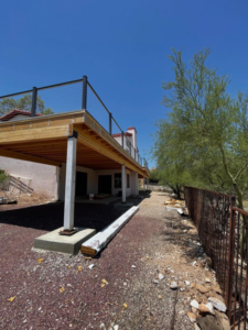 An exterior view of an elevated deck installation project by Raven Construction LLC in Tucson, AZ.