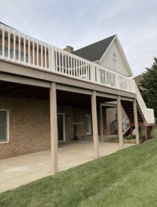 A large elevated deck with white railings and stairs, a completed construction project by DCM Multi Service llc in Harrisburg, PA.