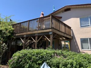 An elevated wooden deck showcasing its sturdy support structure, a project by Dan's Home and Yard in Oakland, CA.