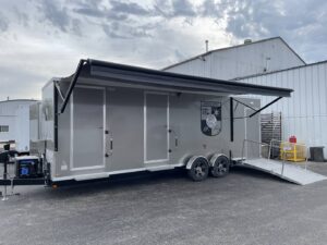 A custom-built emergency services trailer with an awning and ramp, constructed by Comforts of Home Services Inc in Aurora, IL
