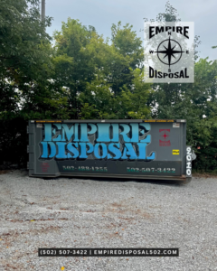 An Empire Disposal dumpster with a blue logo sits on a gravel surface, ready for junk removal in Shepherdsville, KY.