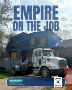 Empire Disposal roll-off truck with a dumpster at a damaged house for junk removal in Shepherdsville, KY.