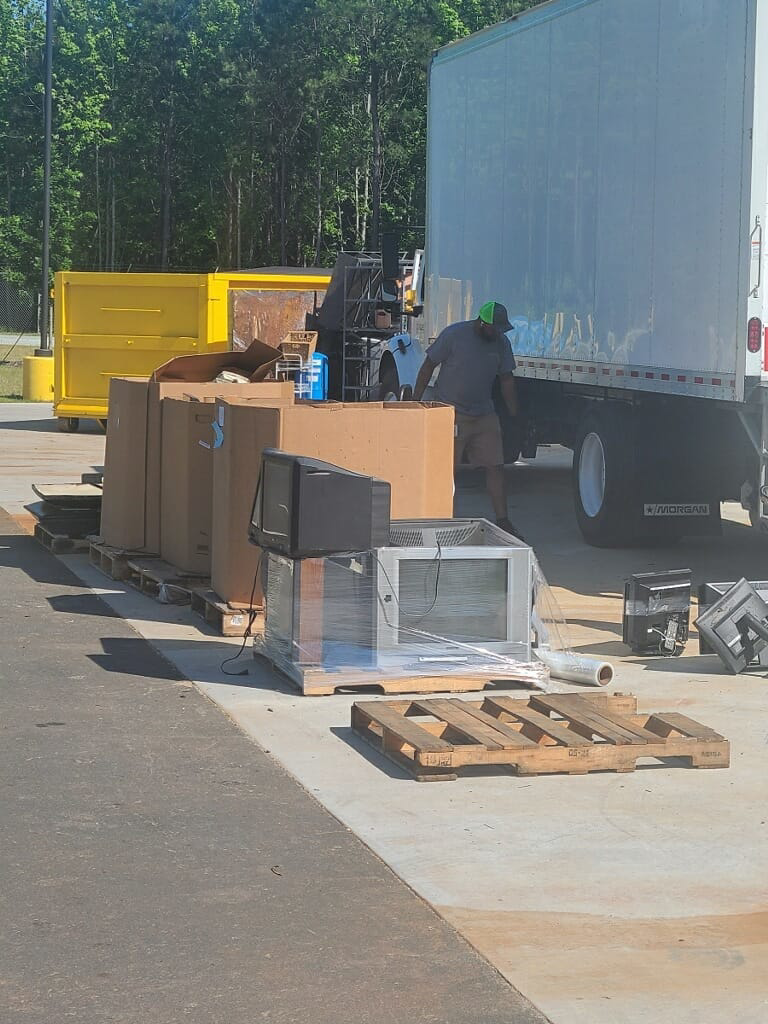 An employee loading electronics onto pallets for recycling at Durham County Recycles in Durham, NC