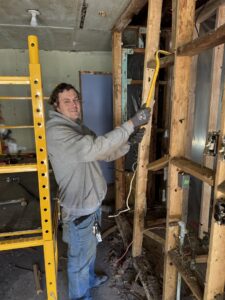 An employee removing debris from a demolition or cleanout job for Waste Walkers Dispatch in Springfield, MO.