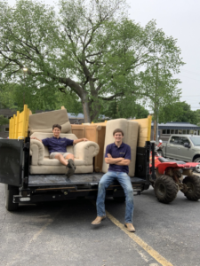 Jack My Junk employees loading furniture onto a truck for junk removal services in St. Charles, MO.