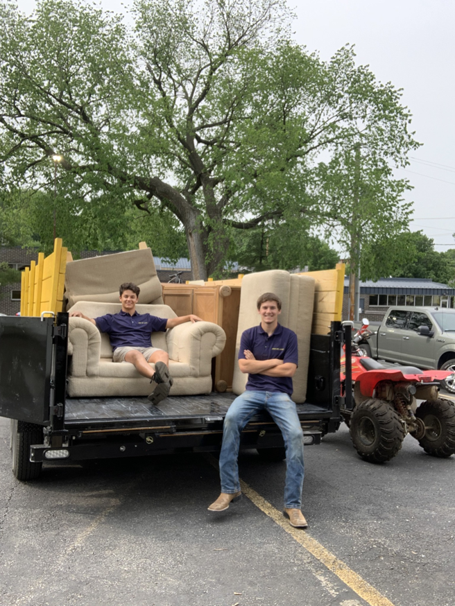 Jack My Junk employees loading furniture onto a truck for junk removal services in St. Charles, MO.