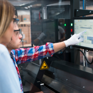 Employees operating specialized machinery for electronic waste recycling at Global Electronic Recycling in Phoenix, AZ.