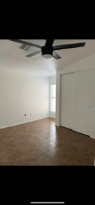 Empty bedroom with new black ceiling fan and fresh paint by Arizona Contracting And Remodeling LLC in Tucson, AZ