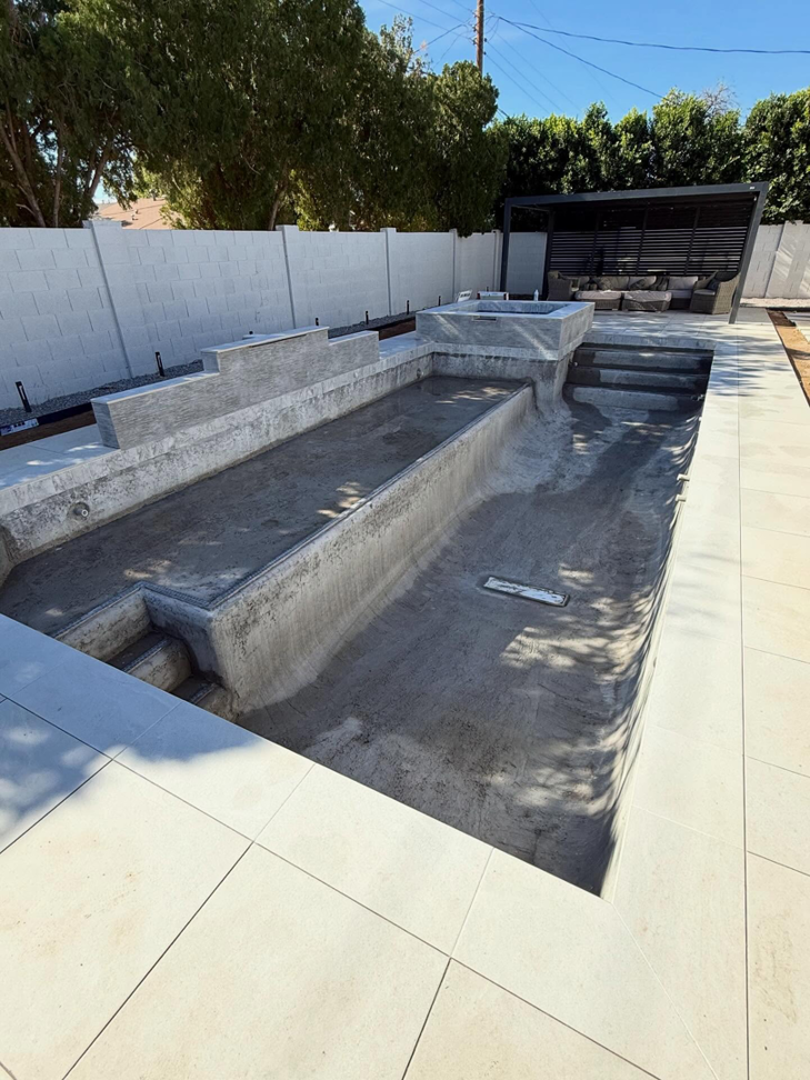 An empty concrete pool shell ready for plastering by Prado & Sons Pool Plastering, Inc. in Glendale, AZ.