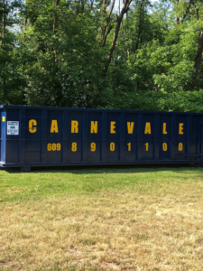 An empty blue dumpster from AJ Carnevale Disposal ready for a junk removal job in Hamilton, NJ