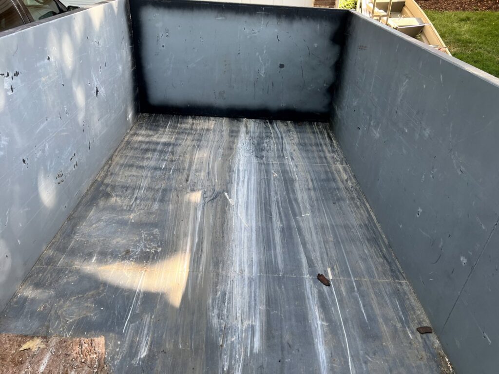 The clean interior of an empty 402 Container dumpster, ready for junk removal in Omaha, NE.