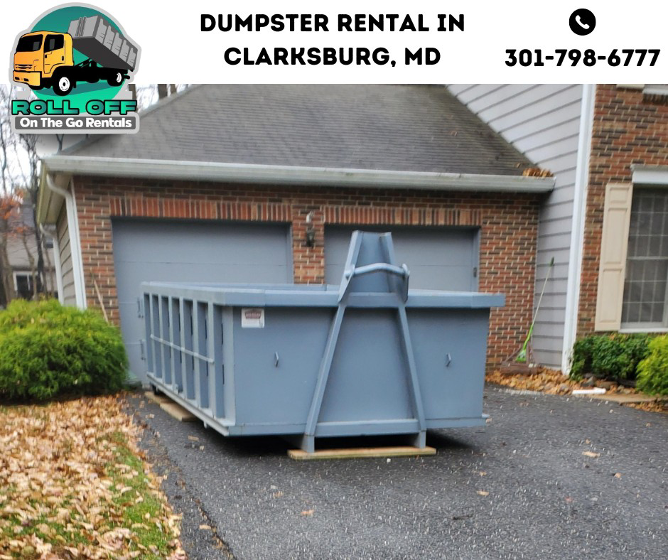 An empty roll-off dumpster placed in a residential driveway for a junk removal project by Roll Off On the Go Rentals in Silver Spring, MD.