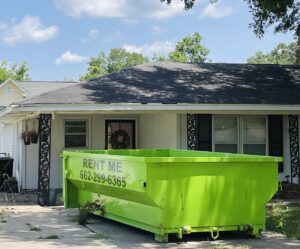 An empty bright green dumpster ready for residential junk removal from Tristate Dumpsters LLC in Greenville, MS.