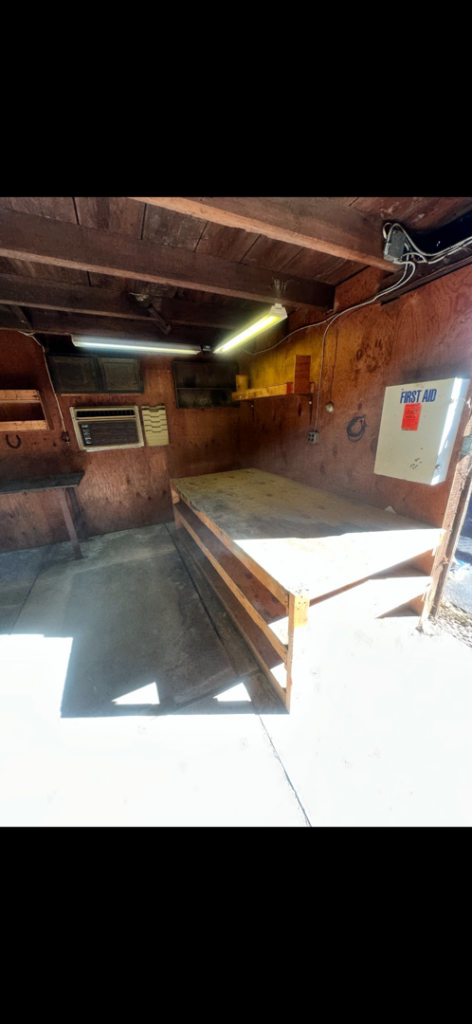 An empty garage with workbenches, showcasing a completed junk removal service by 302-Rid-Junk in Wilmington, DE.