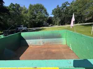 An interior view of an empty green Dump-It Dumpster Rentals dumpster, ready for junk removal in Concord, NH.