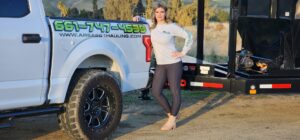 An empty green dumpster from Area 661 Hauling placed on a residential driveway for junk removal in Bakersfield, CA.