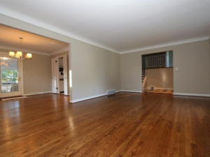An empty living room with hardwood floors and light-colored walls, showcasing potential for remodeling by KLS Remodel in Cincinnati, OH.