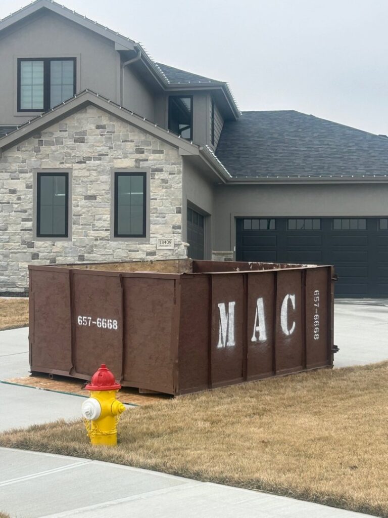 An empty MAC Containers, Inc dumpster delivered for residential junk removal services in Omaha, NE.
