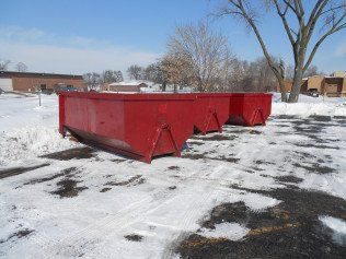 Two empty red roll-off dumpsters from SS ROLL OFF Dumpsters available for junk removal in Rockford, IL.