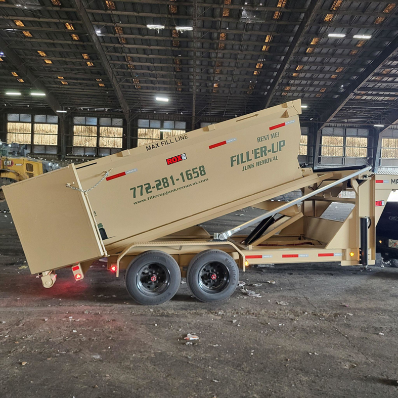 An empty beige roll-off dumpster trailer branded with Fill-ER-UP JUNK Removal LLC, ready for junk removal services in Port Saint Lucie, FL.