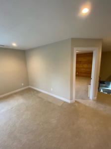 An empty room with light-colored walls and carpet, showcasing potential for remodeling by KLS Remodel in Cincinnati, OH.