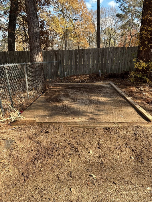 An empty shed foundation after a successful demolition and junk removal service by Nash's Cargo Company LLC in Shreveport, LA.