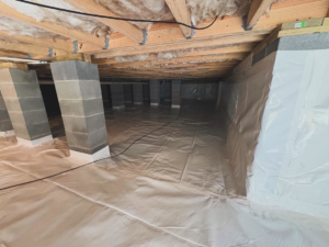 A newly encapsulated crawlspace with a clean vapor barrier and support piers installed by Crawlspace Medic of Knoxville, TN