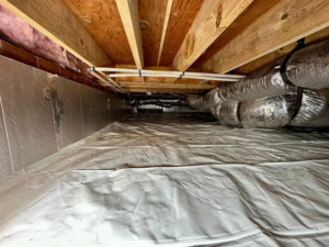 A professionally encapsulated crawlspace with a clean white vapor barrier installed by Ramos Waterproofing & Crawlspace Sealing LLC in Durham, NC.