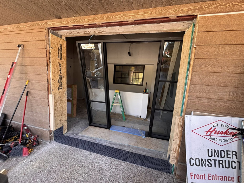 Entryway with a door frame and glass panels being installed by Harwell's Handyman & HVAC Services in Dickson, TN.