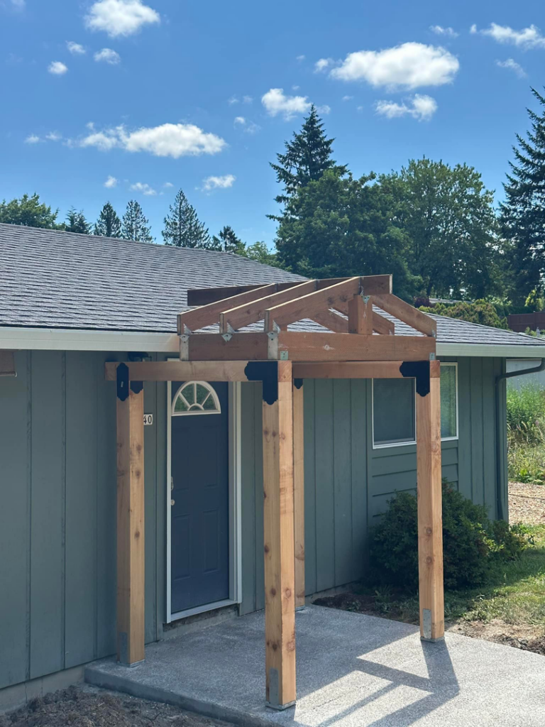 Wooden framing for a new entryway pergola under construction by JJT Construction in Portland, OR.