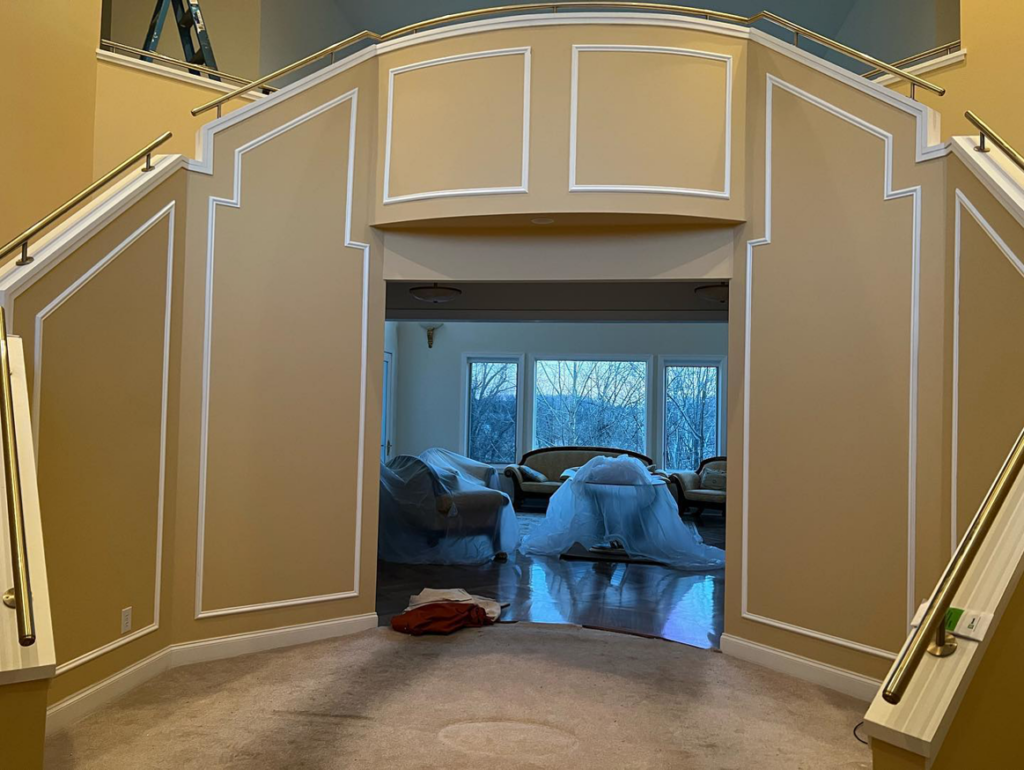 A grand entryway and staircase after remodeling with new paint and trim by VP Remodeling LLC in Duluth, GA.