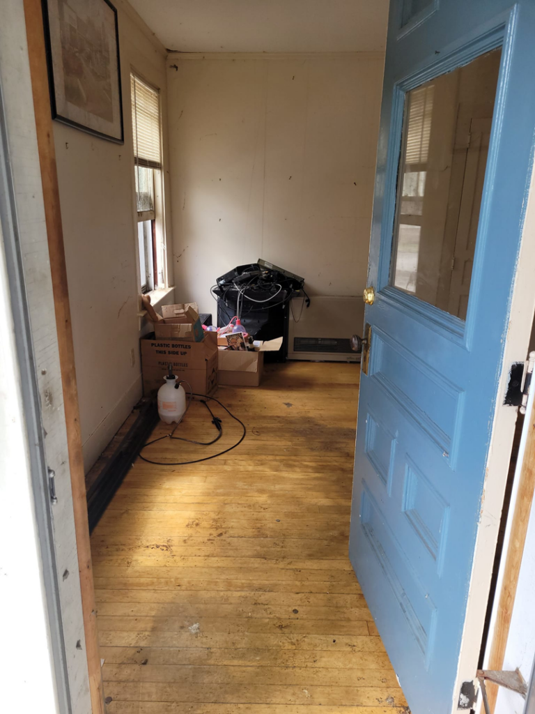 An entryway with trash bags and boxes, awaiting junk removal from Paul's Trash in East Montpelier, VT.