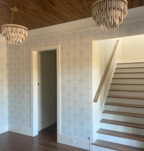 Entryway with new wallpaper and chandelier installation services by Ravenel Construction Group in Mount Pleasant, SC