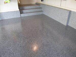 A durable epoxy-coated garage floor and steps, expertly installed by Egli Coating Solutions handyman in Evansville, IN.