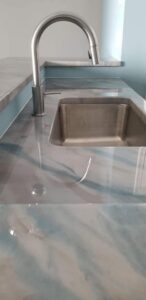 A close-up of a custom epoxy countertop with a unique blue and gray swirl design by Coastal Surface Design in Virginia Beach, VA.