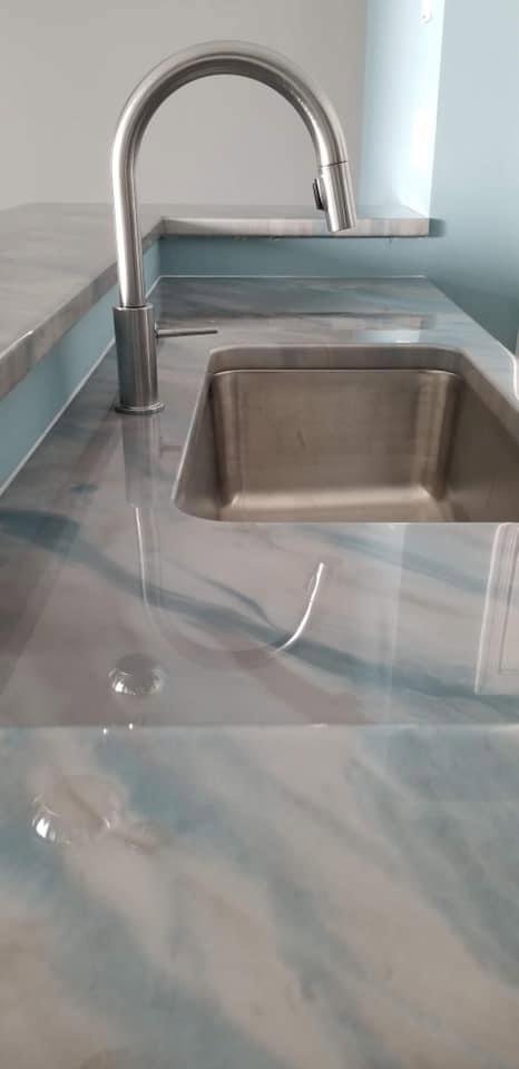 A close-up of a custom epoxy countertop with a unique blue and gray swirl design by Coastal Surface Design in Virginia Beach, VA.