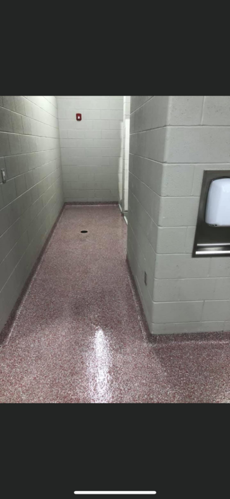 A durable epoxy flake floor installed in a commercial hallway by Kentucky Decorative Concrete in Nicholasville, KY.