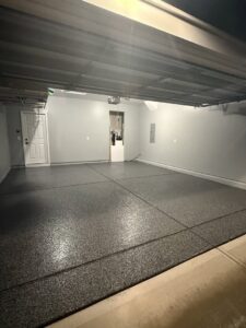 A newly finished garage floor with a durable epoxy flake coating, installed by Rodriguez Concrete Creations in Rock Hill, SC.