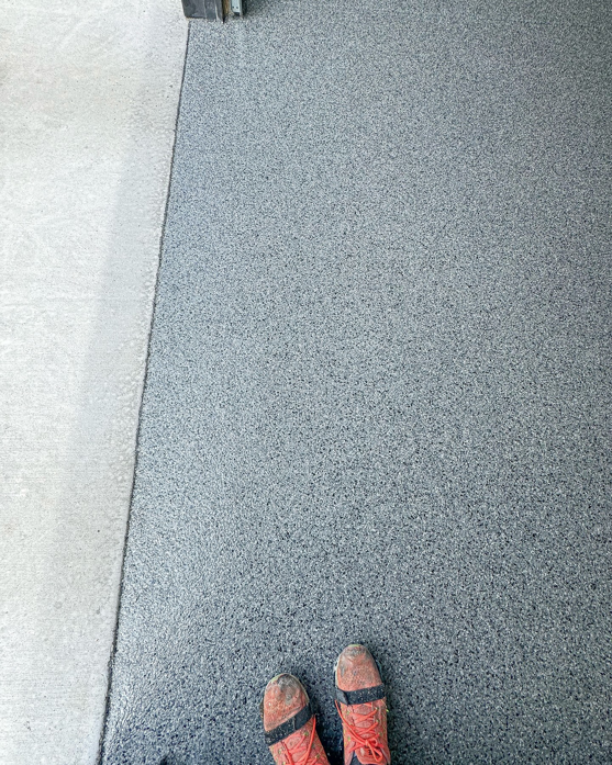 A close-up comparison of a new epoxy floor coating next to original concrete by Apex Custom Coatings in Middleton, WI
