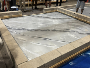 Epoxy floor installation demonstration by CC&J Construction, INC in Bernville, PA, showing a swirled design.