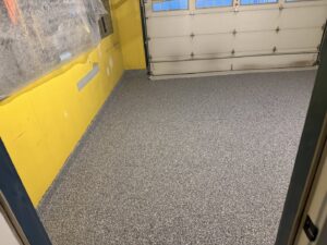 An epoxy garage floor installation in progress by Premier Edge Concrete in Grand Rapids, MI