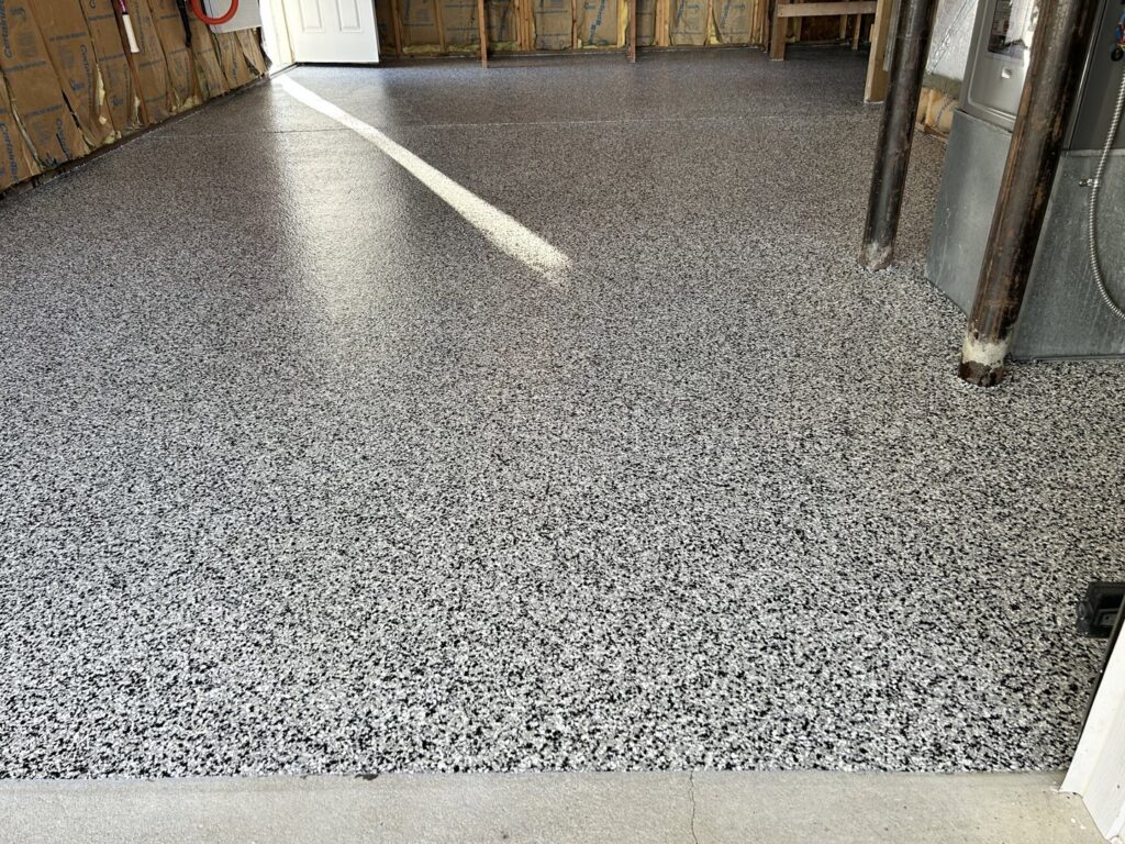 A newly installed speckled epoxy garage floor, a handyman service provided by Randy Overacre Painting Company in Virginia Beach, VA.